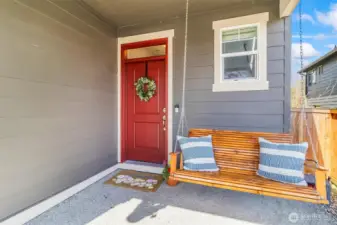 Charming covered front porch with space for seating—perfect for relaxing and welcoming guests.
