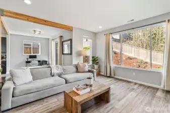 Light-filled great room showcasing open layout, updated flooring, and flexible living spaces.