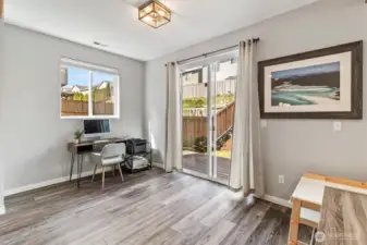 Versatile dining or flex space with sliding door access to backyard and natural light.