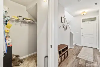 Welcoming entry with convenient coat closet and bench seating.