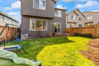 Rear exterior showing deck, patio, and yard space.