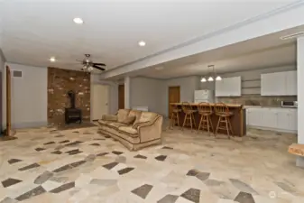 Lower level family room with 2nd kitchen with a wood burning stove