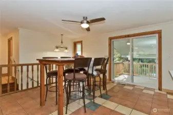 Open concept dining with a slider out to covered back deck and patio