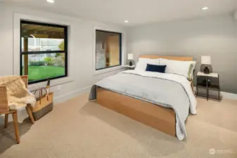 Lower level bedroom with en suite bath and hombre wall paper.