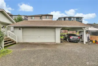 2nd house with a 2 car garage & a carport.