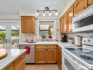 Beautiful Kitchen with vaulted ceiling, skylight,  stainless appliances, garden window & Island.