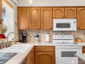 Beautiful Kitchen with vaulted ceiling, skylight,  stainless appliances, garden window & Island.