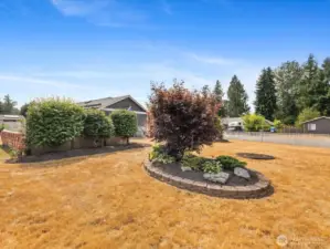Expansive outdoor spaces with fully fenced Yard, Garden, Raised Beds & Outbuilding/Shed.