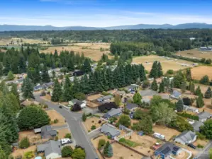Drone view of the large corner lot and surrounding community.