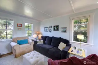 Living room with a great view of the gardens and fully fenced yard.