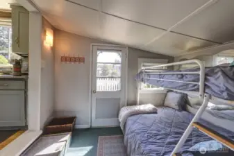 Extra sleeping room with back door.