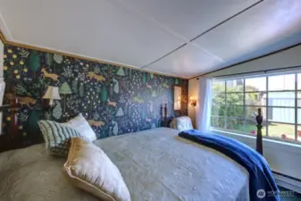 Main bedroom with view of the fully fenced yard and gardens.