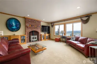 Family room has a cozy gas fireplace and views over the lake.