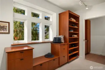The walk-in closet has an abundance of custom built cabinetry and a separate laundry room.