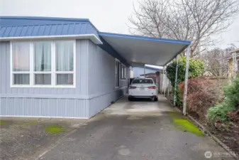Carport with entrance to the laundry room