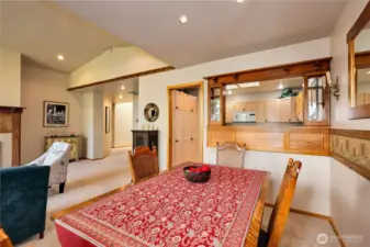 The dining room is adjacent to the kitchen and features a custom wood pass-through.