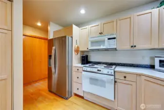 The kitchen leads to the back hall with the laundry closet and entry into the garage.