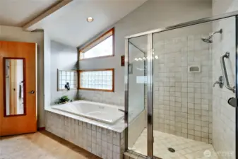 Primary bathroom features large jetted tub and shower.
