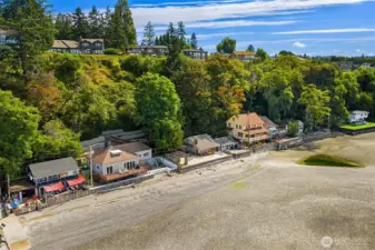 Nestled among mature trees with walk down steps from street level.