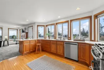 Open airy kitchen with stainless appliances.