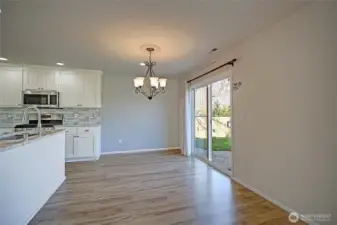 Dining area with access to backyard & patio.
