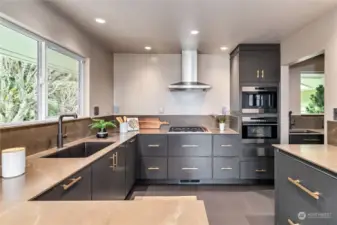 Kitchen features Wolf 4-burner Gas Range, Steam Oven, integrated Espresso Machine, & Warming Drawer