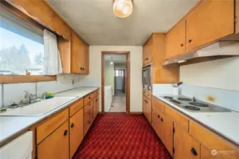 Classic style with the kitchen opening up to the utility room. The door to the back patio is on the left past the washer and dryer.