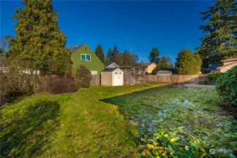 Another view of the backyard - looking toward the sheds and alley access. The smaller, tan shed will likely be removed by seller prior to closing.