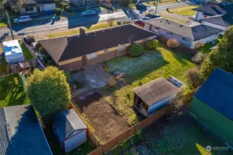 Showing the large backyard and alley access - there used to be a shed on the dirt - easy to make more covered parking.