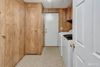 Laundry room with closet and cabinets plus door into 2nd bathroom and exterior deck