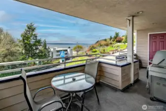 The large full length of unit covered deck.  A great space for relaxing with your morning coffee or bringing in your guests to enjoy an afternoon BBQ