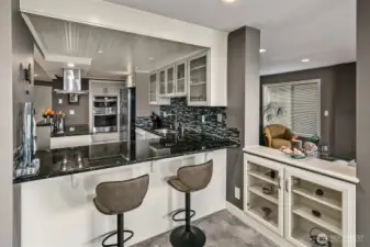 Kitchen looking from dining room space into the open eating bar.  Nice built-in glass cabinet for your glassware next to eating bar.