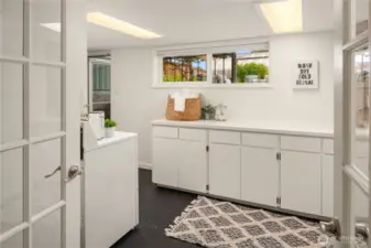 This huge laundry room features great storage, linoleum floors and an outside entrance to the backyard and garage. (one of 3 convenient exterior doors)