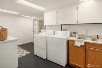 More than ample storage, a laundry sink and gorgeous linoleum flooring. There are 2 more large storage rooms in addition this and the bedrooms & home office.