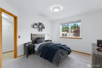 Second bedroom on the upper level with a walk-in closet.