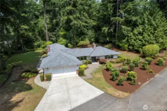 Drone shot of this wonderful home showing beautiful landscaping.New roof with transferable warranty to new owner.New paint both in and out.