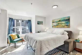 With this configuration, there is space for two bedside tables, plus the Queen sized bed. Also, the window seat and a lounging chair.