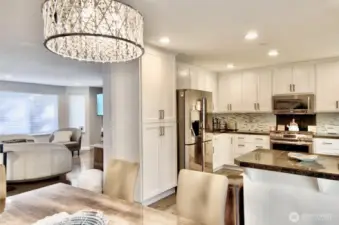 Kitchen open to dining with granite counter top