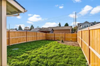 Step outside from the living room into the fully fenced backyard and enjoy the sun!
