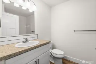 Just to the left of the ground floor bedroom is the first full bath featured in the home!