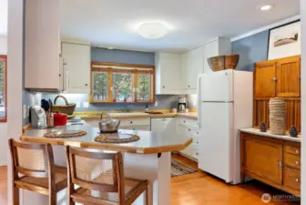 Kitchen has all appliances including 2 Drawer Dishwasher, New Refrigerator, New Electric Range & Oven, Microwave. Harwood cherry floors. Breakfast snack eating area. Wood cabinets. Side Hutch coneys with sale.