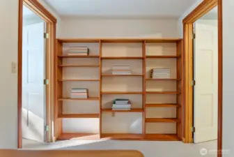 Loft Library reading and device nook. Carpeted. Wood Shelves. Upper level between Primary Bedroom and 2nd bedroom. Small office area.