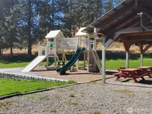 Playground activity jungle gym for the children. Covered picnic table and gathering area.  Ample parking. Large greenbelt grass acreage maintained by the HOA.