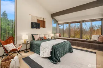 Primary bedroom offers vaulted ceilings, generous space, and beautiful views of the Sound.