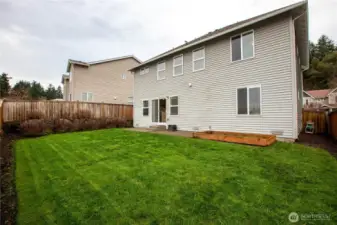 fully fenced backyard with garden box