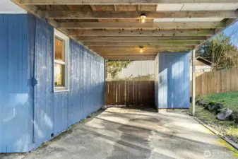 Carport with storage shed.
