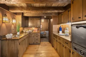 A full-on view of the spacious butler's pantry which features a vintage working oven and a sink. Note the amazing ceiling in this room and the ample counter space perfect for serving up a hearty meal!