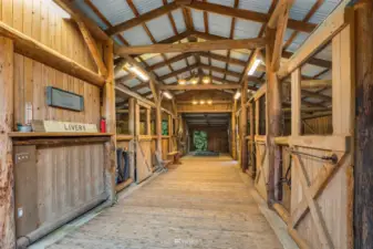 One of two barns. This one has a fabulous tack room and 6 stalls. Several stalls have walk out areas.