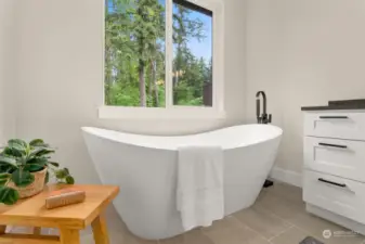 Primary suite bathroom with double sinks, soaker tub and shower with glass surround