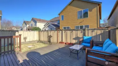 Outside, enjoy low-maintenance landscaping, fenced backyard & charming deck.